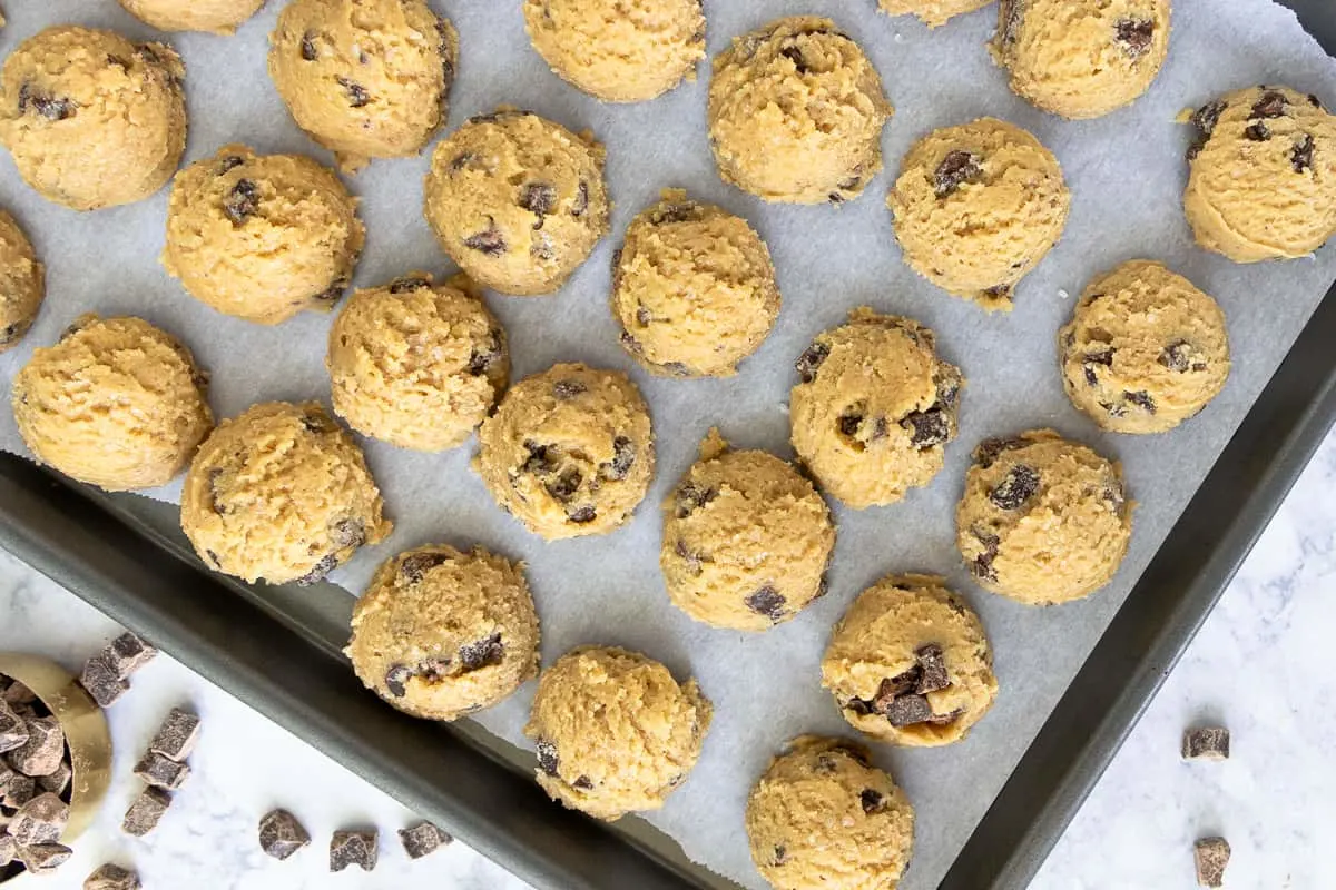 unbaked olive oil cookie dough resting on a baking sheet