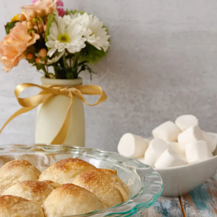 baked resurrection rolls in a dish with flowers in the background