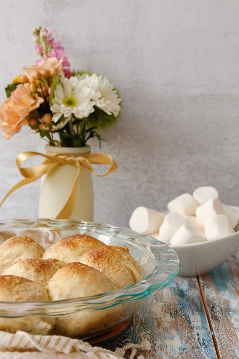 baked resurrection rolls in a dish with flowers in the background