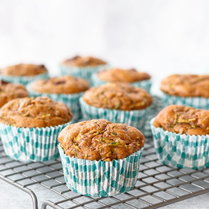 zucchini muffins on a cooling rack with a light background