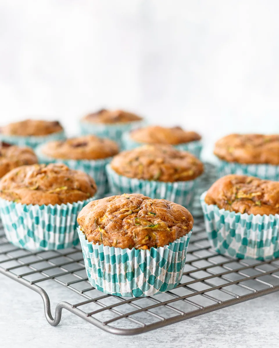 zucchini muffins on a cooling rack with a light background