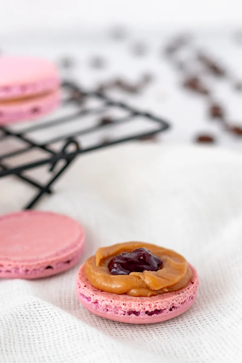 picture of an open macaron showing the filling placement