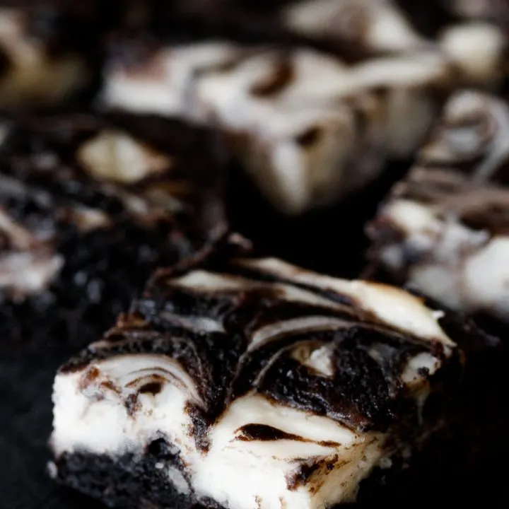 angled top view of the black velvet cheesecake brownies to show the lovely swirl