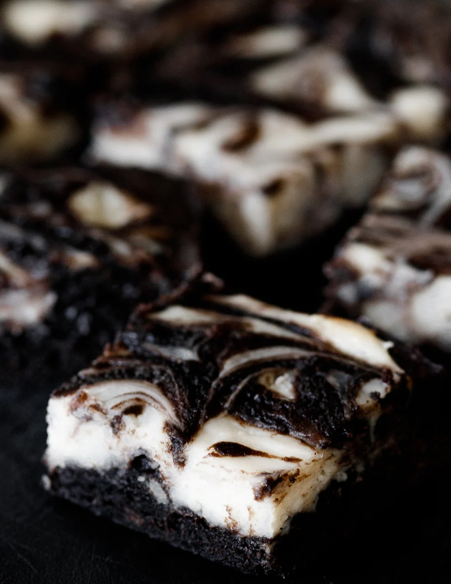 angled top view of the black velvet cheesecake brownies to show the lovely swirl