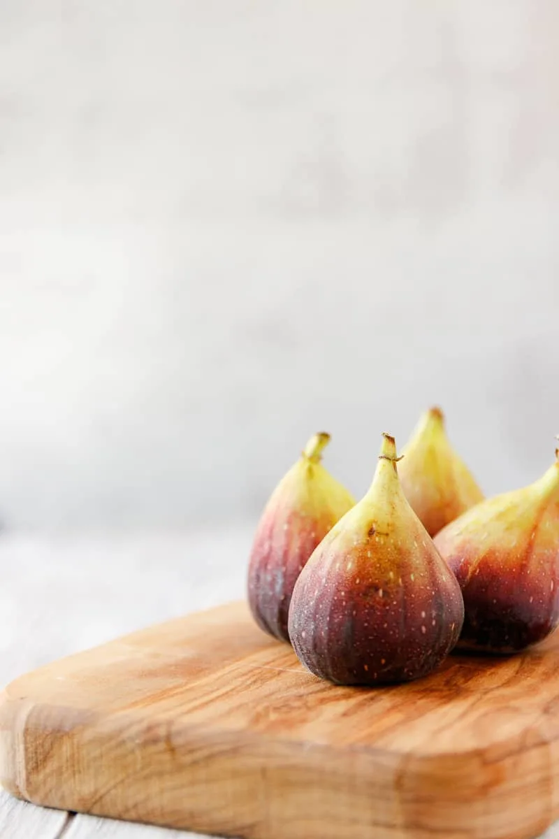 fresh figs on a wooden cutting board