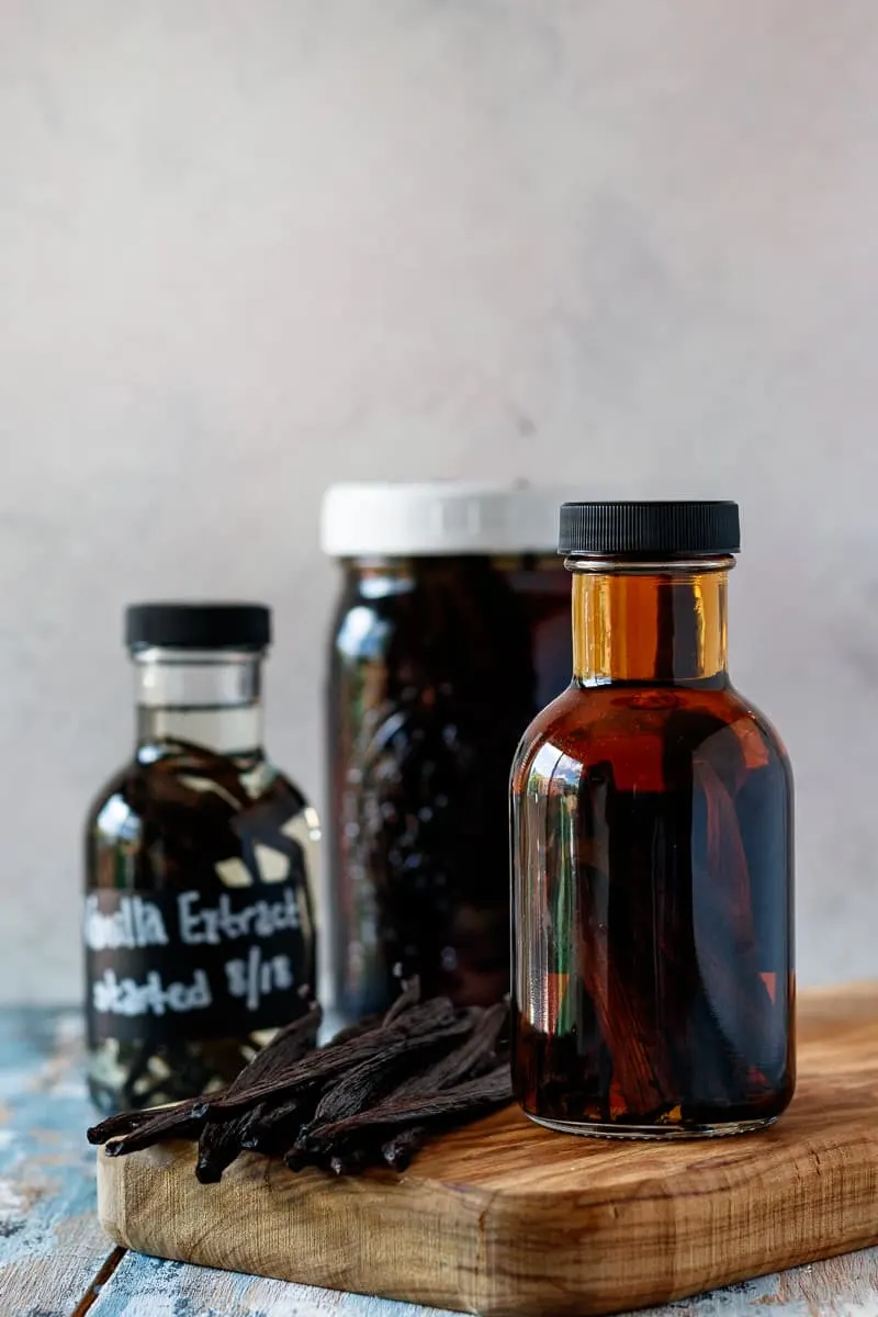 how to make vanilla extract - 3 extract bottles in different stages of preparation