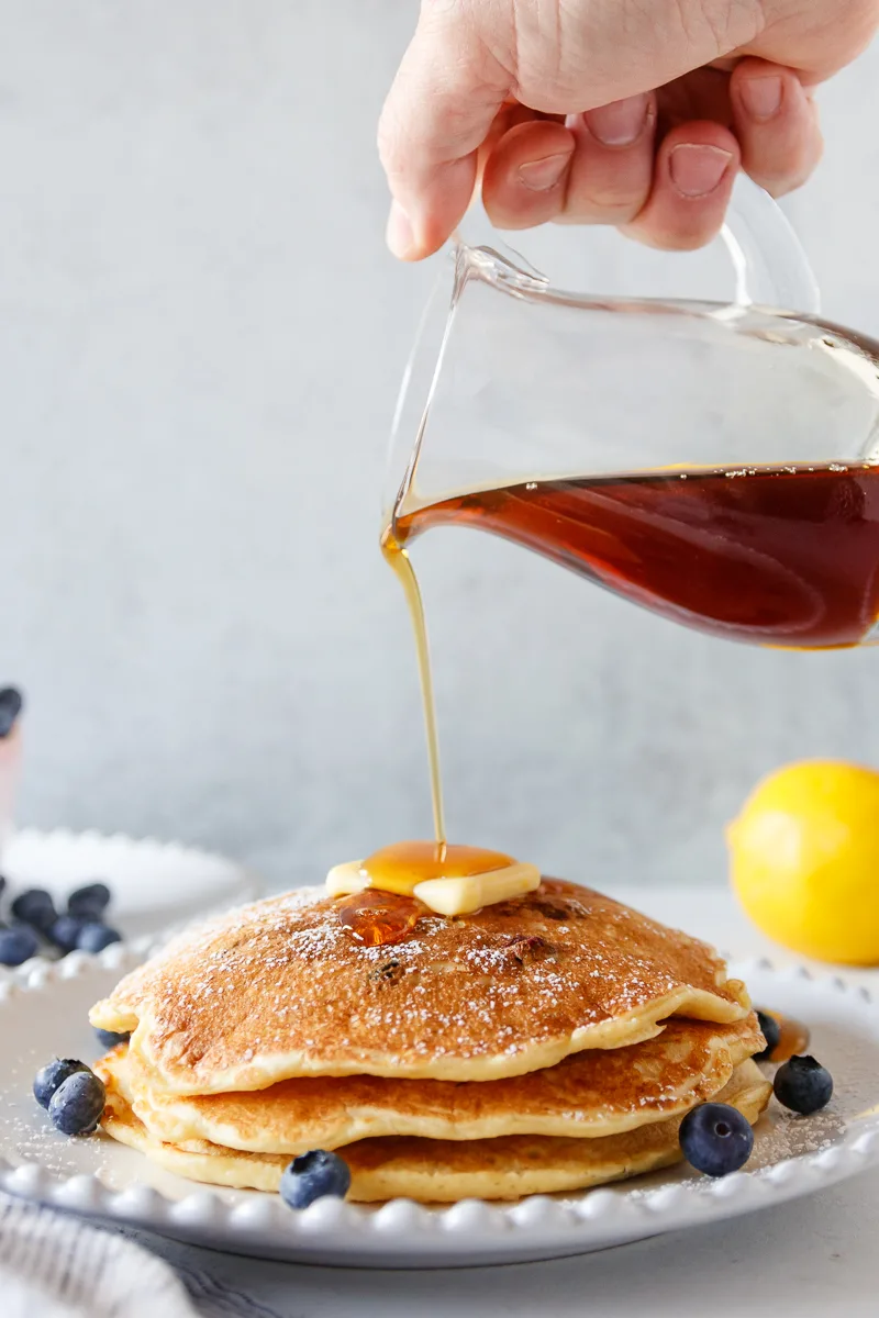 pouring syrup on pancakes