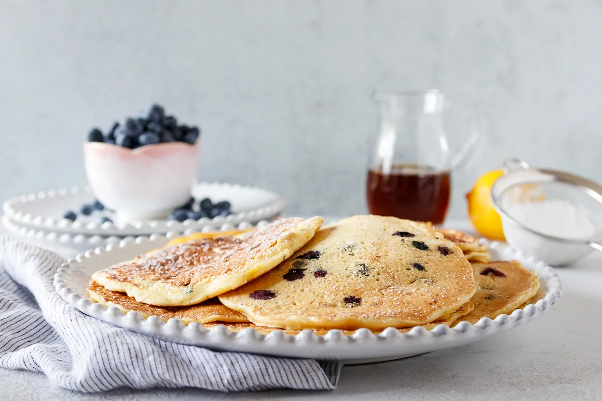 lemon blueberry pancakes on a plate with no toppings yet