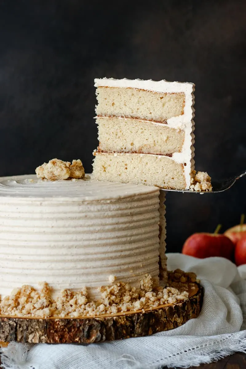 slice of brown sugar layer cake being lifted out of the cake. A great way to show texture and cross section of a slice. 