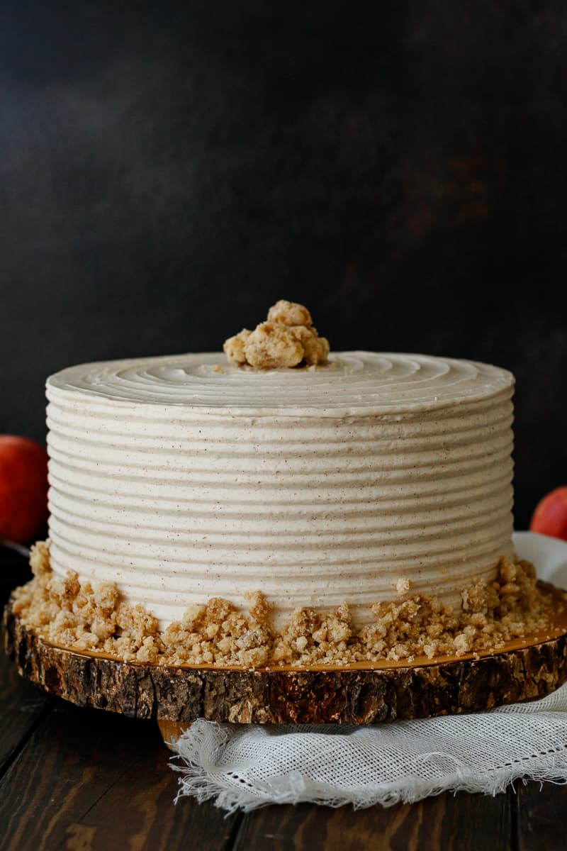 Brown Sugar Layer Cake with cinnamon frosting on a wooden cake board