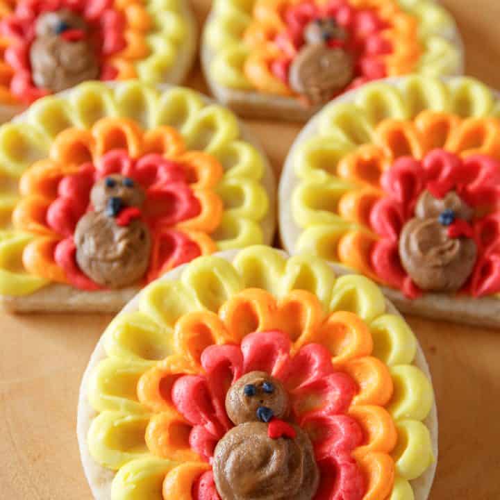 easy turkey cookies decorated with buttercream frosting and arranged on a wood serving platter
