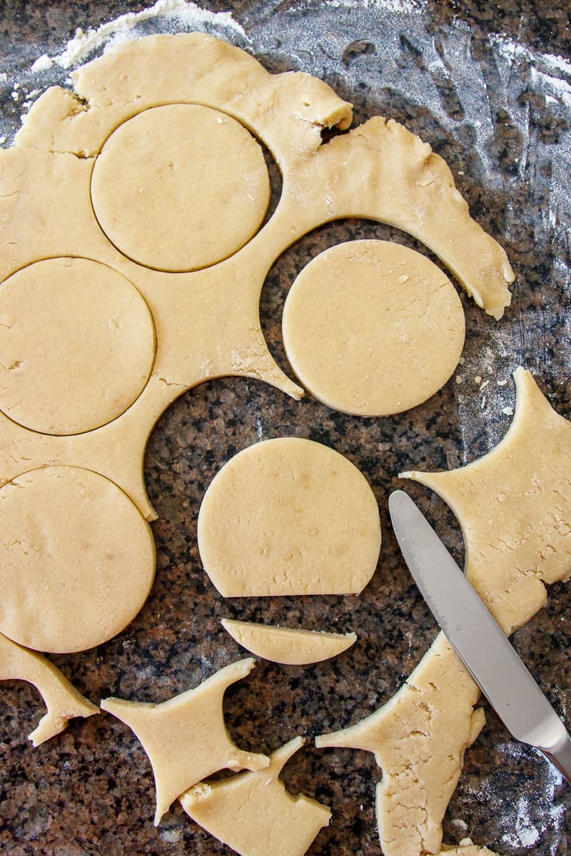 round sugar cookie dough with a little cut off the bottom of a circle to show how to get the shape for these turkey sugar cookies