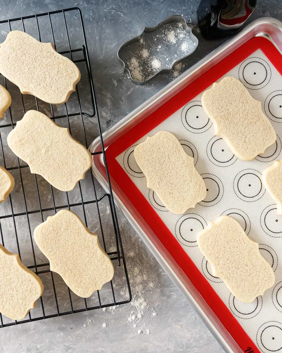 top view of the soft sugar cookies on a baking sheet and a wire rack