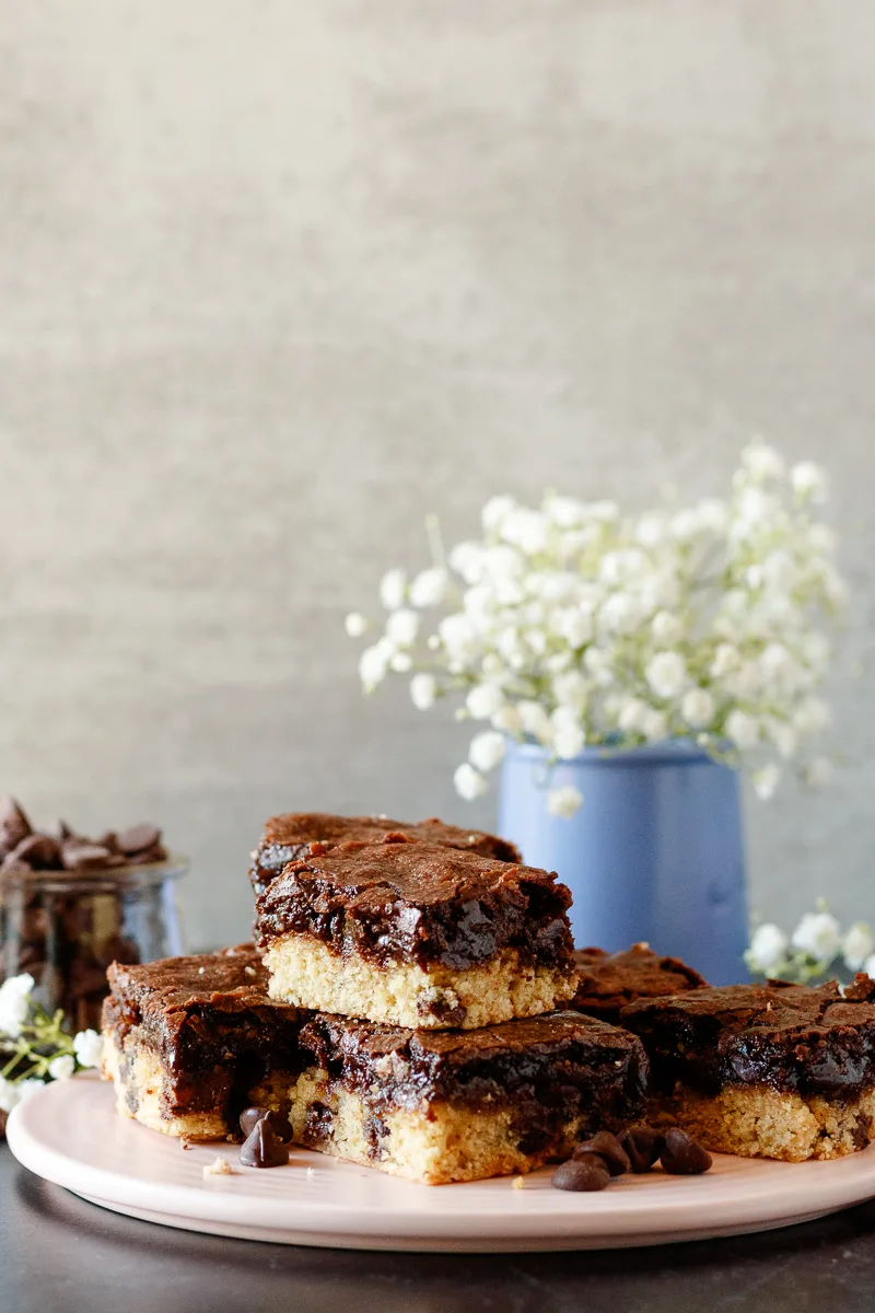 brookie bars with a small vase of baby's breath in the background