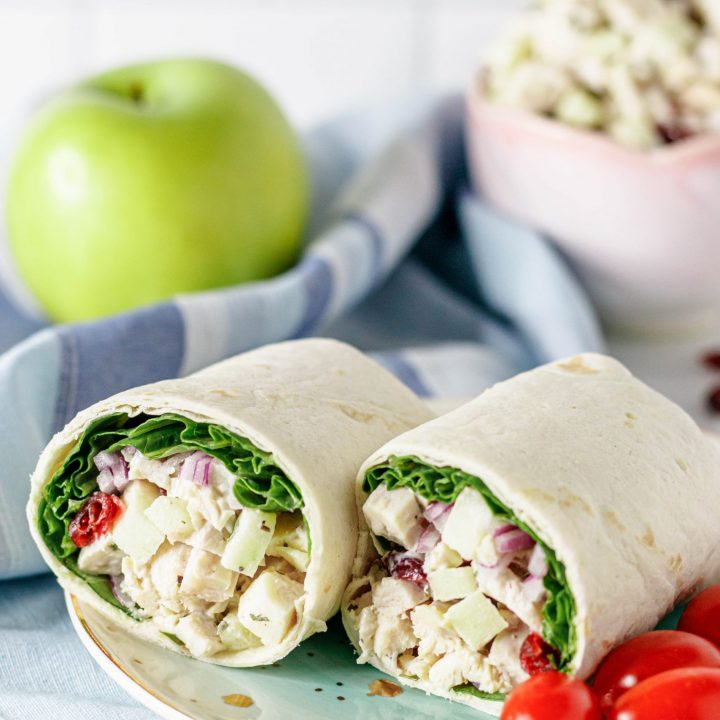 plated chicken salad wraps ready to serve with cherry tomatoes on the side