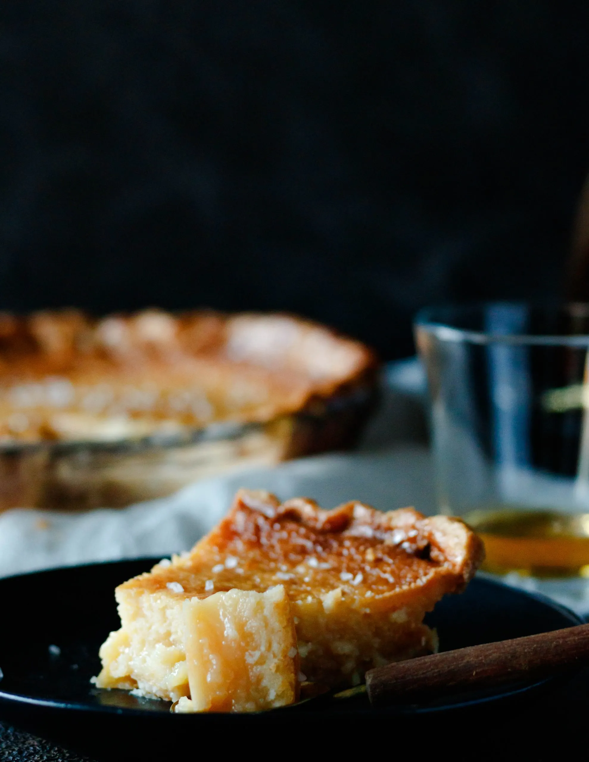 close up of the slice of salted whiskey honey pie with a bite sitting on a spoon