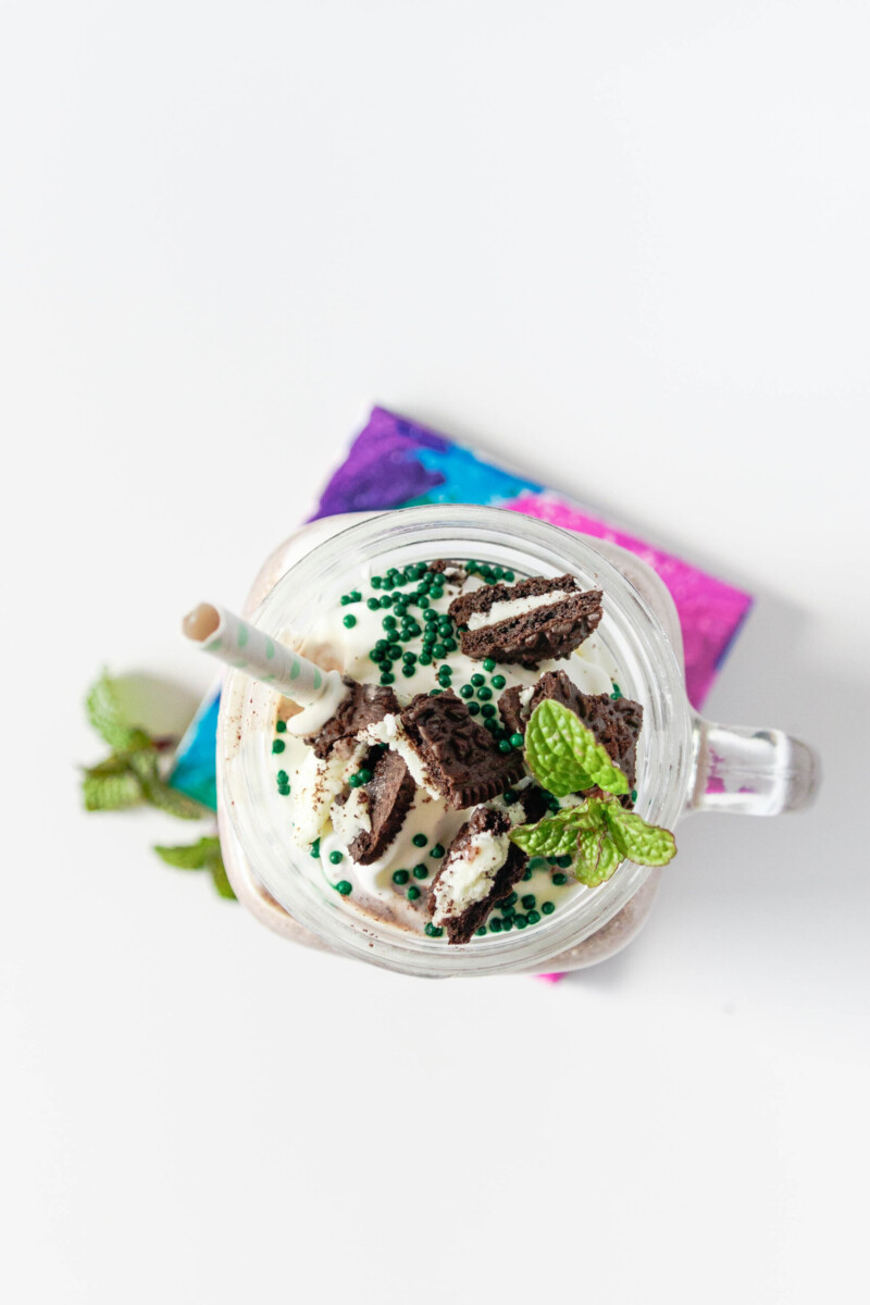 top view of the shake to show the green sprinkles, chopped cookies, and whipped cream