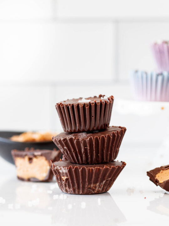 stacked chocolate cashew butter cups with a sprinkle of coarse salt