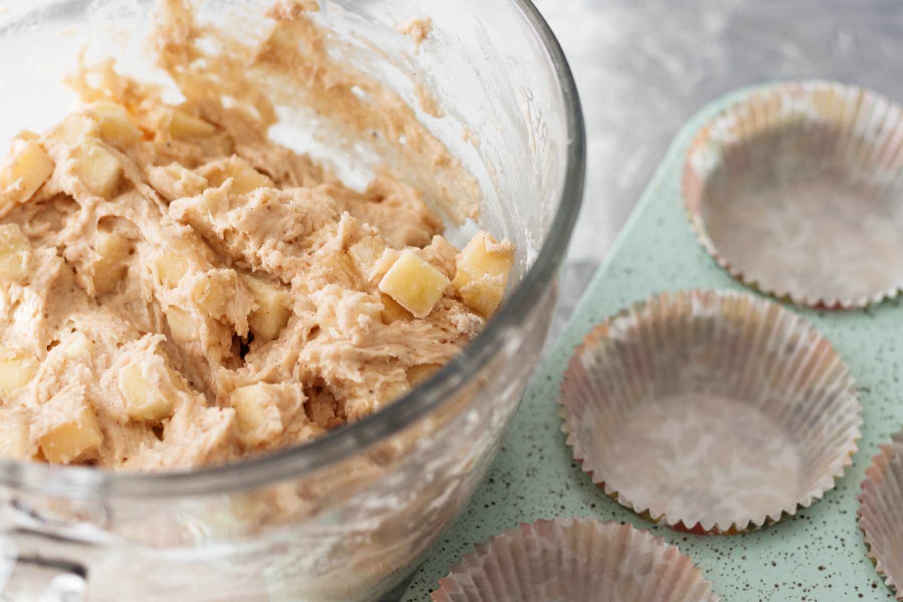 apple muffin batter with fresh apples mixed in
