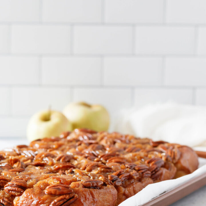 apple pecan sticky buns, baked and inverted onto a rimmed baking sheet lined with parchment