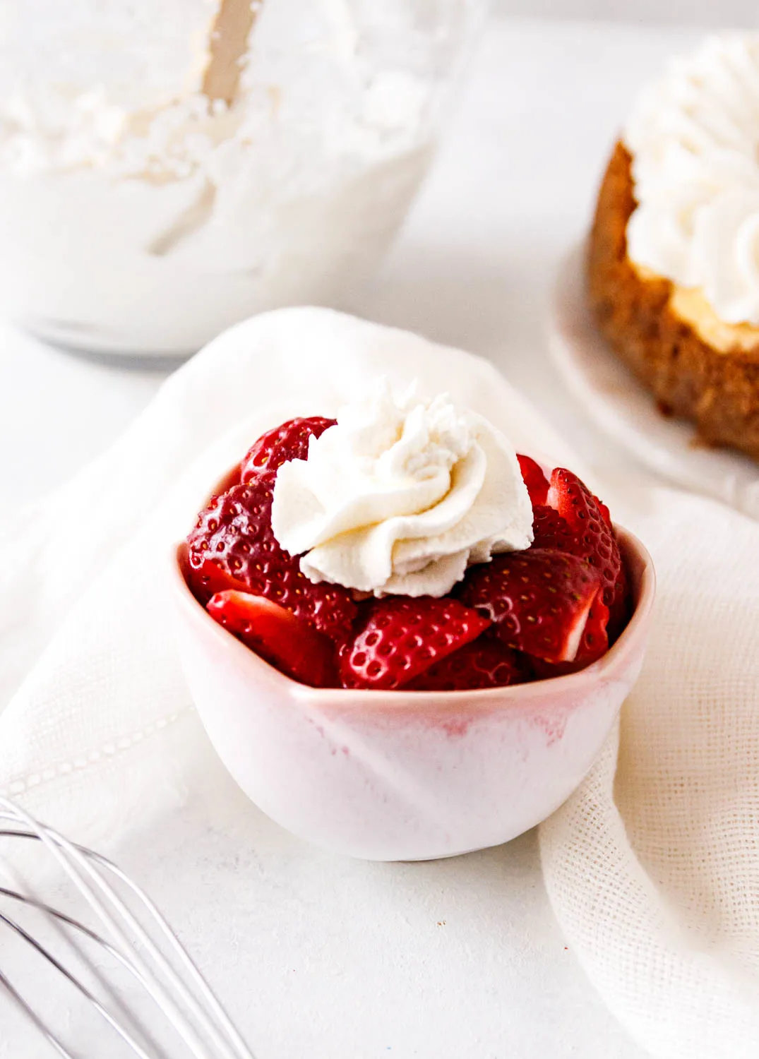 Serving suggestion image showing a bowl of strawberries with whipped cream.