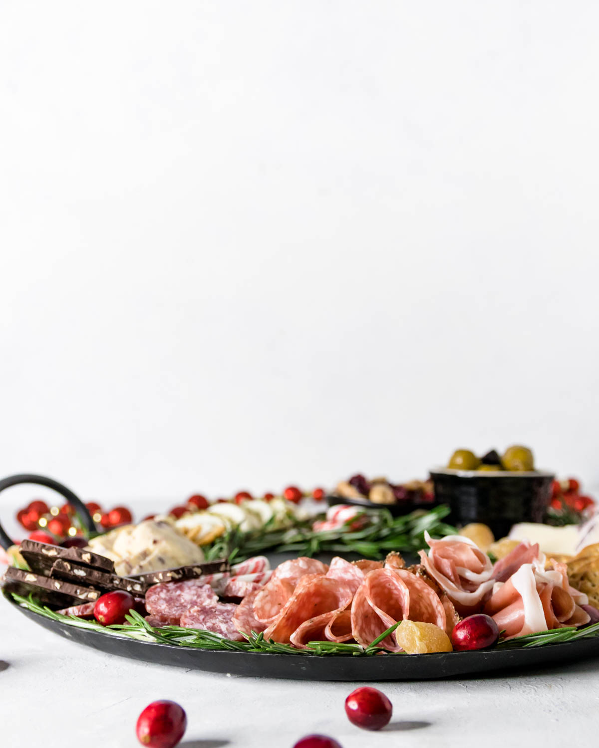 a christmas charcuterie board on a light table with a white background