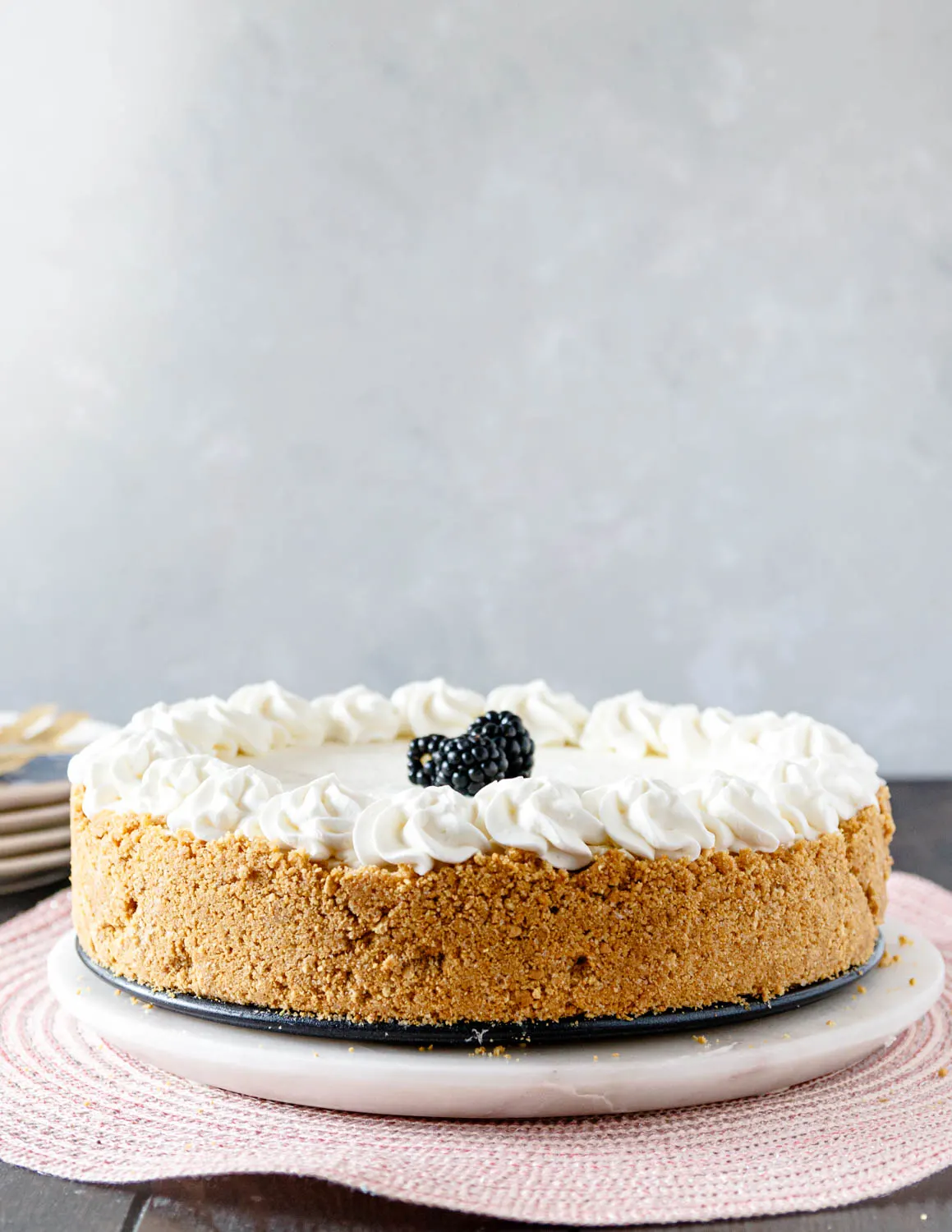 https://goodiegodmother.com/wp-content/uploads/2022/03/whole-no-bake-cheesecake-on-a-serving-dish.jpg.webp