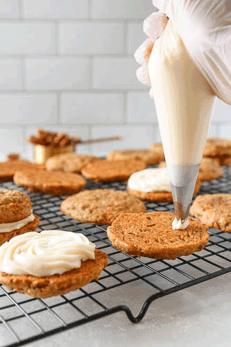 animated gif of cream cheese frosting being piped onto a cookie in a rose swirl 