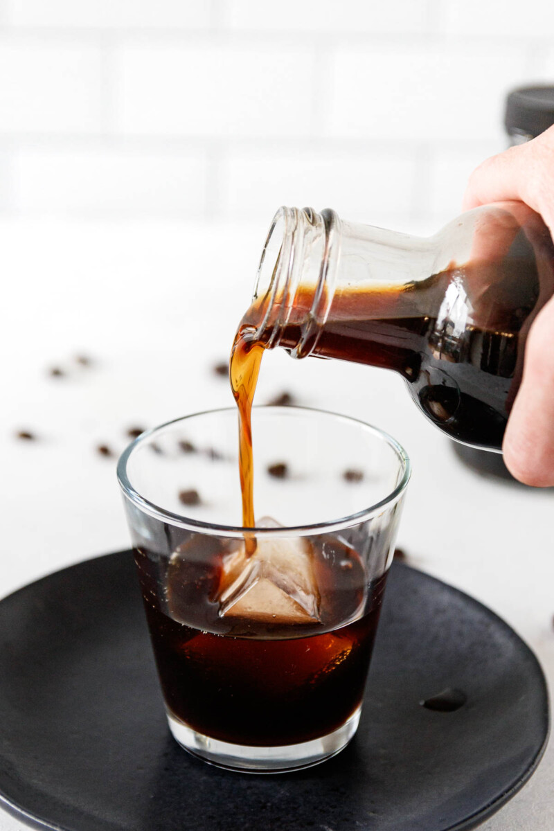 pouring homemade coffee liquor into a glass