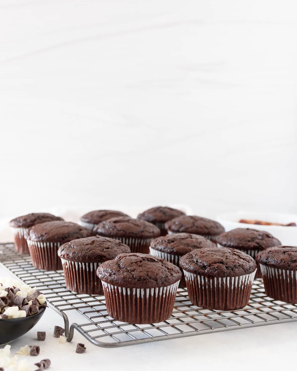 baked chocolate cupcakes on a cooling rack