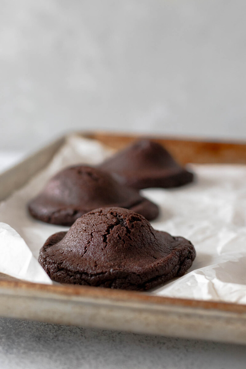 undecorated baked chocolate cookies on a baking sheet